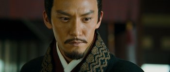 Movie still from “Red Cliff” (2008), directed by John Woo – A person wearing a suit and tie; Close Up shot, High angle