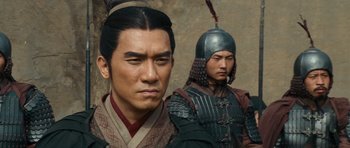 Movie still from “Red Cliff” (2008), directed by John Woo – Two asian men in traditional clothing and helmets; Close Up shot, Over the shoulder angle