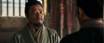 Movie still from “Red Cliff” (2008), directed by John Woo – A man in a robe is standing in front of a window; Close Up shot, Over the shoulder angle