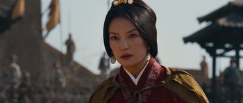Movie still from “Red Cliff” (2008), directed by John Woo – A woman in a red dress with a bee on her head; Close Up shot, Over the shoulder angle