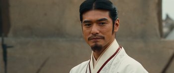 Movie still from “Red Cliff” (2008), directed by John Woo – A man in a white shirt and a black beard; Close Up shot, Over the shoulder angle