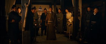Movie still from “Red Cliff” (2008), directed by John Woo – A group of men standing in a room with lit candles; Wide shot, High angle