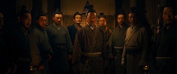 Movie still from “Red Cliff” (2008), directed by John Woo – A group of men standing next to each other in a room; Medium shot, Low angle