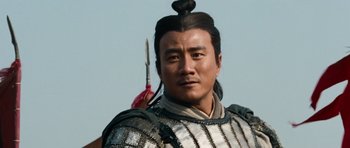Movie still from “Red Cliff” (2008), directed by John Woo – A person with a bow in his hair; Close Up shot, Low angle