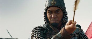 Movie still from “Red Cliff” (2008), directed by John Woo – A person wearing armor and holding a sword; Close Up shot, Low angle