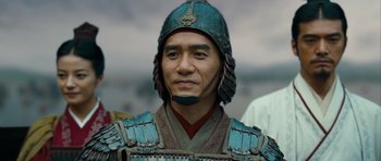 Movie still from “Red Cliff” (2008), directed by John Woo – A man wearing a blue helmet and a red and brown uniform; Close Up shot, Over the shoulder angle