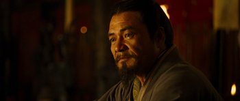 Movie still from “Red Cliff” (2008), directed by John Woo – A person with a beard wearing a robe; Close Up shot, Over the shoulder angle