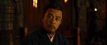 Movie still from “Red Cliff” (2008), directed by John Woo – A man in a black robe is looking at the camera; Close Up shot, Over the shoulder angle