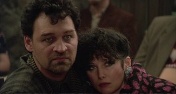 Movie still from “Red Heat” (1988), directed by Walter Hill – A man and a woman pose for a picture; Close Up shot, Low angle