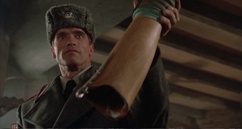 Movie still from “Red Heat” (1988), directed by Walter Hill – A man in a russian military uniform holding a rifle; Close Up shot, Low angle