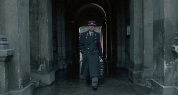 Movie still from “Red Heat” (1988), directed by Walter Hill – A man in a military uniform walking through a tunnel; Wide shot, Low angle