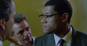 Movie still from “Red Heat” (1988), directed by Walter Hill – Two men in business suits looking at each other; Close Up shot, Over the shoulder angle