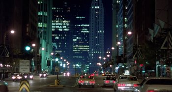 Movie still from “Red Heat” (1988), directed by Walter Hill – A city street at night lit up by street lights; Extreme Wide shot, Low angle