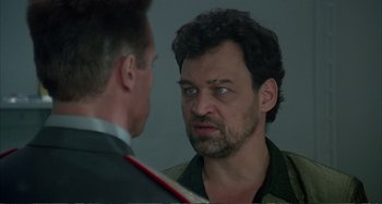 Movie still from “Red Heat” (1988), directed by Walter Hill – A man looking at himself in the mirror; Close Up shot, Over the shoulder angle