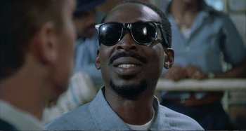 Movie still from “Red Heat” (1988), directed by Walter Hill – A person wearing sunglasses; Close Up shot, Low angle