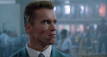 Movie still from “Red Heat” (1988), directed by Walter Hill – A person wearing a suit and tie; Close Up shot, Low angle