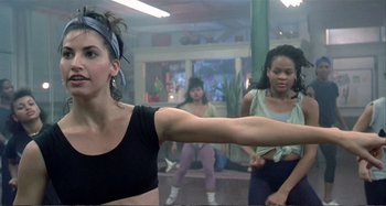 Movie still from “Red Heat” (1988), directed by Walter Hill – A group of young women doing different exercises; Medium shot, Over the shoulder angle