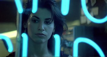 Movie still from “Red Heat” (1988), directed by Walter Hill – A woman's face in front of blue neon lights; Close Up shot, Low angle