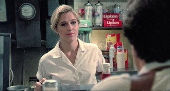 Movie still from “Red Heat” (1988), directed by Walter Hill – A woman sitting in front of a mirror in a store; Close Up shot, Over the shoulder angle