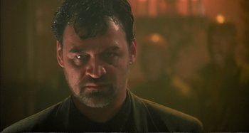 Movie still from “Red Heat” (1988), directed by Walter Hill – A person wearing a black shirt; Close Up shot, Low angle