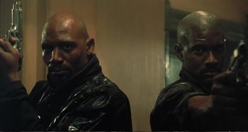 Movie still from “Red Heat” (1988), directed by Walter Hill – A man with a shaved head and a man with a shaved head; Close Up shot, Low angle