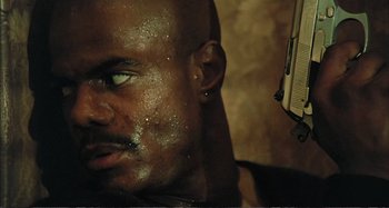 Movie still from “Red Heat” (1988), directed by Walter Hill – A man's face and ear piercings; Close Up shot, Low angle