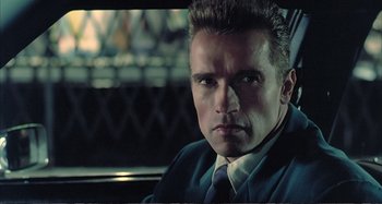 Movie still from “Red Heat” (1988), directed by Walter Hill – A person wearing a suit and tie; Close Up shot, Low angle
