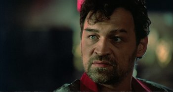Movie still from “Red Heat” (1988), directed by Walter Hill – A person wearing a red shirt; Close Up shot, Low angle