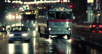 Movie still from “Red Heat” (1988), directed by Walter Hill – A bus driving down a street at night; Wide shot, Low angle