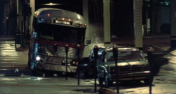 Movie still from “Red Heat” (1988), directed by Walter Hill – A bus and a car crash on a city street at night; Wide shot, High angle