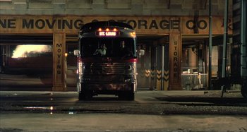 Movie still from “Red Heat” (1988), directed by Walter Hill – A bus is driving down the street at night; Extreme Wide shot, Low angle