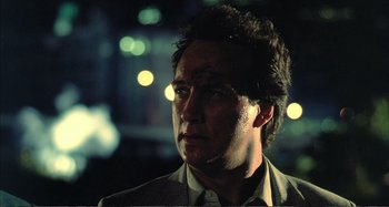 Movie still from “Red Heat” (1988), directed by Walter Hill – A person wearing a suit and tie; Close Up shot, Low angle