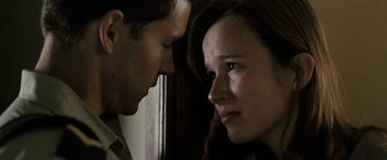 Movie still from “Red Hill” (2010), directed by Patrick Hughes – A man and a woman face to face in front of a wall; Close Up shot, Over the shoulder angle