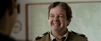 Movie still from “Red Hill” (2010), directed by Patrick Hughes – A person wearing a uniform; Close Up shot, Over the shoulder angle