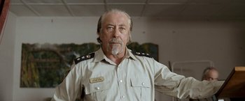 Movie still from “Red Hill” (2010), directed by Patrick Hughes – An older man in a military uniform posing for a picture; Close Up shot, Low angle