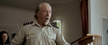 Movie still from “Red Hill” (2010), directed by Patrick Hughes – An older man with a beard wearing a military uniform; Close Up shot, Low angle