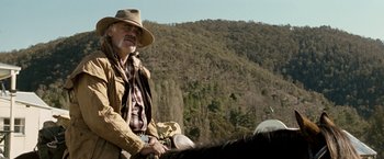 Movie still from “Red Hill” (2010), directed by Patrick Hughes – An older man riding on the back of a horse; Medium shot, Low angle