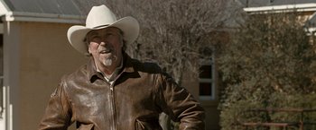Movie still from “Red Hill” (2010), directed by Patrick Hughes – An older man wearing a cowboy hat and a leather jacket; Medium shot, Over the shoulder angle
