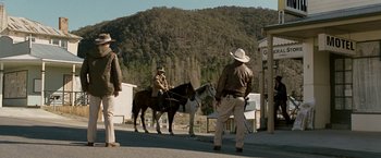 Movie still from “Red Hill” (2010), directed by Patrick Hughes – A couple of men riding horses down a street; Wide shot, Low angle