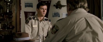 Movie still from “Red Hill” (2010), directed by Patrick Hughes – A man in uniform sitting in front of another man in uniform; Close Up shot, Over the shoulder angle