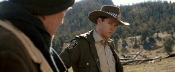 Movie still from “Red Hill” (2010), directed by Patrick Hughes – A man in a police uniform and a hat; Close Up shot, Over the shoulder angle