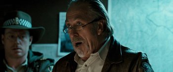 Movie still from “Red Hill” (2010), directed by Patrick Hughes – An older man with glasses and a beard; Close Up shot, Over the shoulder angle