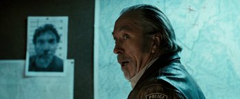 Movie still from “Red Hill” (2010), directed by Patrick Hughes – An older man with a police badge on his jacket; Close Up shot, Over the shoulder angle