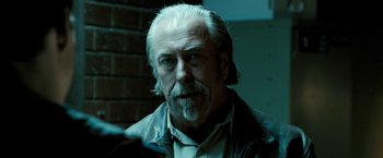 Movie still from “Red Hill” (2010), directed by Patrick Hughes – An older man with white hair is looking at the camera; Close Up shot, Over the shoulder angle