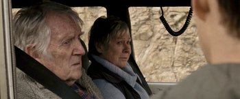 Movie still from “Red Hill” (2010), directed by Patrick Hughes – An older man and a woman sitting in a car; Close Up shot, Over the shoulder angle