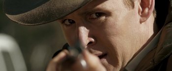Movie still from “Red Hill” (2010), directed by Patrick Hughes – A man wearing a hat and holding a gun; Extreme Close Up shot, Over the shoulder angle