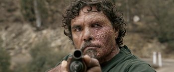 Movie still from “Red Hill” (2010), directed by Patrick Hughes – A person holding a gun; Close Up shot, Low angle