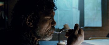 Movie still from “Red Hill” (2010), directed by Patrick Hughes – An older man eating something with a spoon; Close Up shot, Over the shoulder angle