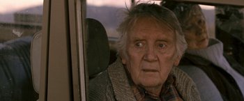 Movie still from “Red Hill” (2010), directed by Patrick Hughes – An old man sitting in a car looking out the window; Close Up shot, Over the shoulder angle