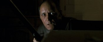 Movie still from “Red Hill” (2010), directed by Patrick Hughes – An older man holding a cell phone in his hand; Close Up shot, Low angle